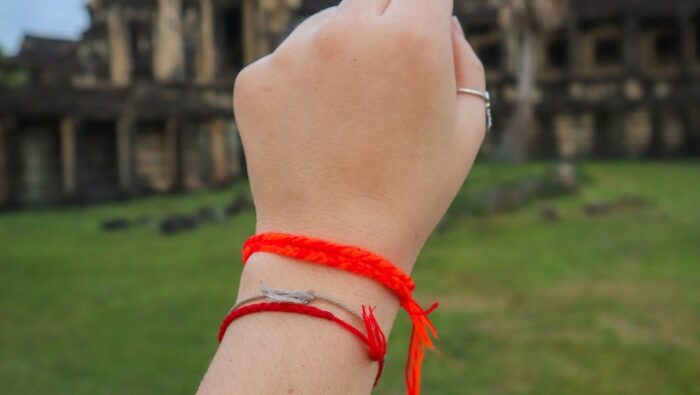 Should I Wear a Red String Bracelet on My Right or Left Wrist featured image by tina caro magickal spot